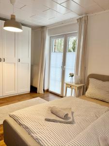 a bedroom with a bed with a towel on it at Ferienhaus Sandstrand in Cuxhaven