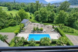 an aerial view of a resort with a swimming pool at Hotel Nessi Locarno in Locarno