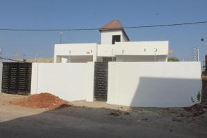 a white fence in front of a white house at MB Properties - situated behind Dalaba Estate about 500 meters from the famous OIC road in Madina Sey Kunda +1 photo
