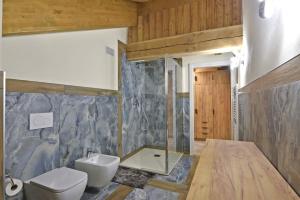 a bathroom with a white toilet and a sink at ArtiStone - "The Modern Loft" - Nature and Relax in Saint-Christophe