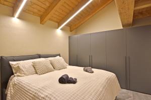a bedroom with a bed with two slippers on it at ArtiStone - "The Modern Loft" - Nature and Relax in Saint-Christophe