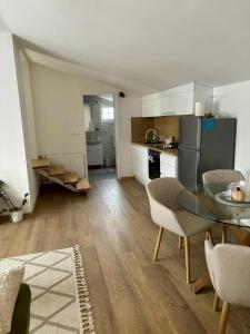 a kitchen with a table and chairs in a room at Apartman Lukas in Županja