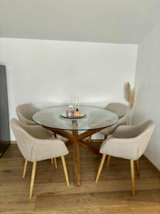 a dining room with a glass table and chairs at Apartman Lukas in Županja