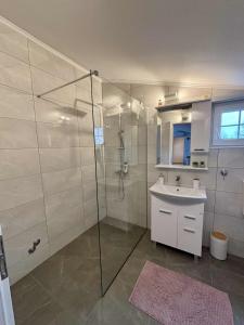 a bathroom with a shower and a sink at Apartman Lukas in Županja