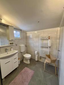a bathroom with a toilet and a sink at Apartman Lukas in Županja +8 photos