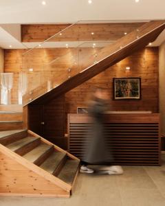 a person walking down a staircase in a building at Bianca Hotel & Villa Tirana in Tirana +161 photos