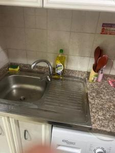 a kitchen counter with a sink and a dishwasher at Studio in Ajman in Ajman  +7 photos