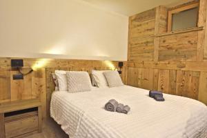 a bedroom with a bed with shoes on it at ArtiStone - "Ancient Lodge" in Saint-Christophe