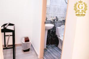 a bathroom with a toilet and a sink at Green Shade Resort & Haritha Sewana Hotel in Nallathanniya