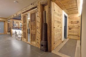 a hallway with wooden walls and a fireplace in a house at ArtiStone - "Ancient Lodge" in Saint-Christophe