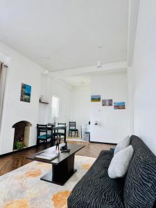 a living room with a couch and a table at Misty5 in Pattipola