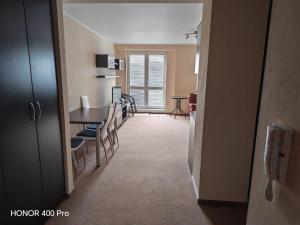a living room with a table and a dining room at Tatra Frank Apartman in Štrba +3 photos
