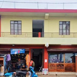 a building with a motorcycle parked in front of it at Hotel Kiara In Shillong in Shillong
