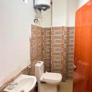 a bathroom with a toilet and a sink at Hotel Kiara In Shillong in Shillong
