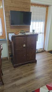 a tv on top of a dresser in a room at Chalet La Cometa in Sauze dʼOulx