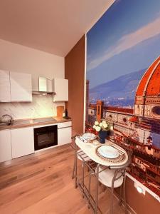 a kitchen with a table and a view of a city at Ama Esclusive Spa Firenze in Florence