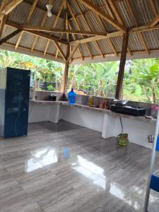 a large outdoor kitchen with a counter in a pavilion at Jambu Tree Homestay in Tanjungjati +44 photos