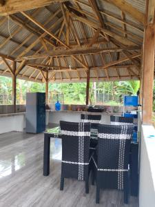 a table and chairs in a room with a kitchen at Jambu Tree Homestay in Tanjungjati