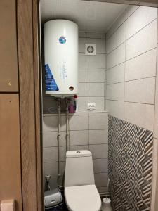 a small bathroom with a toilet and a water tank at Шале 1077 метрів над рівнем моря in Krivopolʼye +14 photos