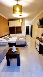 a hotel room with two beds and a table at Bešeňová Apartment in Bešeňová