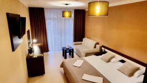 a hotel room with a bed and a couch at Bešeňová Apartment in Bešeňová