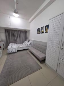 a living room with a couch and a bed at Apartment in ajman in Ajman  +11 photos