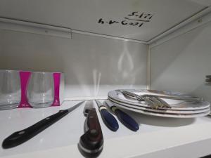 a table with a knife and a plate and glasses at Apartment in ajman in Ajman 