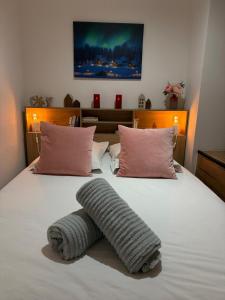 a bed with a knitted object on top of it at Cocon Des Bois - Gex Genève Mijoux in Mijoux