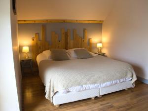 a bedroom with a large white bed with two lamps at Cottage l'Orée du Cher in Chissay-en-Touraine +11 photos