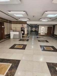 a large room with a tile floor and a lobby at Apartment in ajman in Ajman 