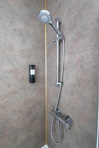 a shower with a shower head on the floor at Bignold Park View in Orkney +44 photos