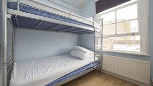 a bunk bed in a room with a window at Queen Elizabeth Hostel in London