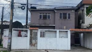 a house with a white fence in front of it at Casa Carnaval Olinda 2026 in Recife