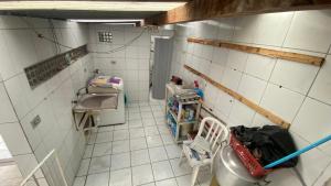 a small kitchen with a sink and a tiled floor at Casa Carnaval Olinda 2026 in Recife +11 photos