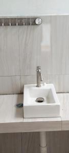 a white sink in a bathroom with a mirror at Jambu Tree Homestay in Tanjungjati