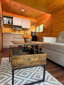 a living room with a couch and a table at Finca Milele in Macanal