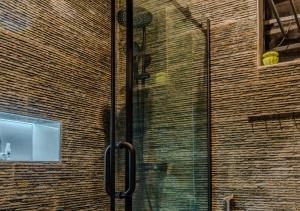 a glass door on a brick wall with a window at Rooks Rest Inn & Apartments in Lagos +46 photos