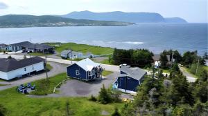 an aerial view of a house and the water at Drift Ashore House in Rocky Harbour