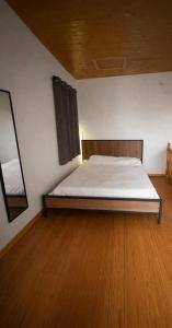a bed in a room with a wooden floor at Kathryns apartment in Sinarádes