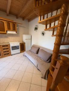 a kitchen with a couch in the middle of a room at Kathryns apartment in Sinarádes