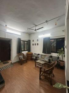 a living room with a couch and a table at Tripvana Backpacker Hostel in Nashik