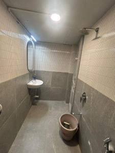a bathroom with a toilet and a sink at Tripvana Backpacker Hostel in Nashik +37 photos