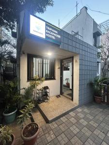 a building with a sign on the front of it at Tripvana Backpacker Hostel in Nashik