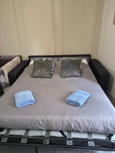 a bed with two pillows on top of it at La Douce Escale studio in Courseulles-sur-Mer