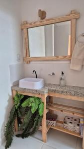 a bathroom with a sink and a mirror at Refúgio da Lagoa de Araruama - AP 202 in Araruama +8 photos