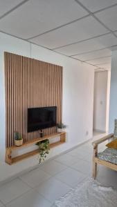 a living room with a flat screen tv on a wall at Refúgio da Lagoa de Araruama - AP 202 in Araruama