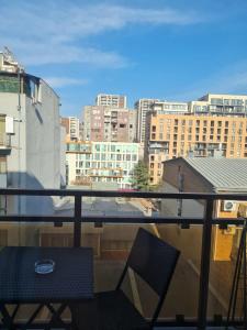 a balcony with a chair and a view of a city at Ia's Home in Tbilisi City