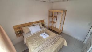 a bedroom with a bed with two towels on it at Refúgio da Lagoa de Araruama - AP 202 in Araruama