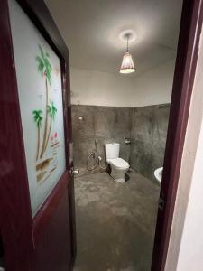 a bathroom with a toilet and a sink at Lagoon Home Stay in Ahangama