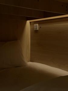 a bed in a room with a wooden wall at Soulstay Bangkok in Bangkok
